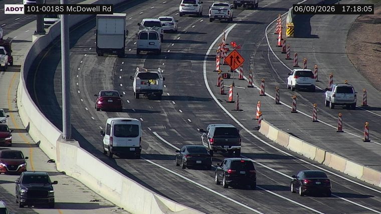 Construction cones and orange traffic barrels in the right lanes