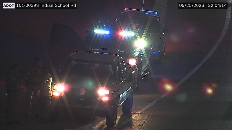 Police car with blue and red lights on the shoulder