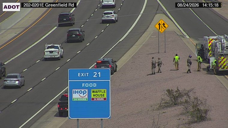 Fire truck and several individuals on the right shoulder