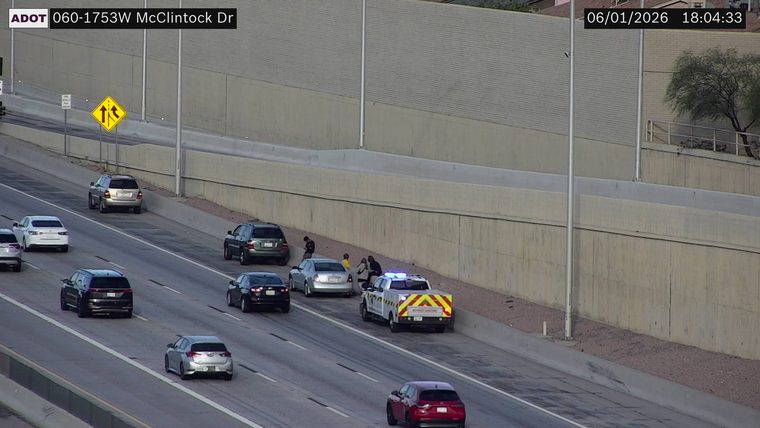 Emergency vehicle and several people on the right shoulder