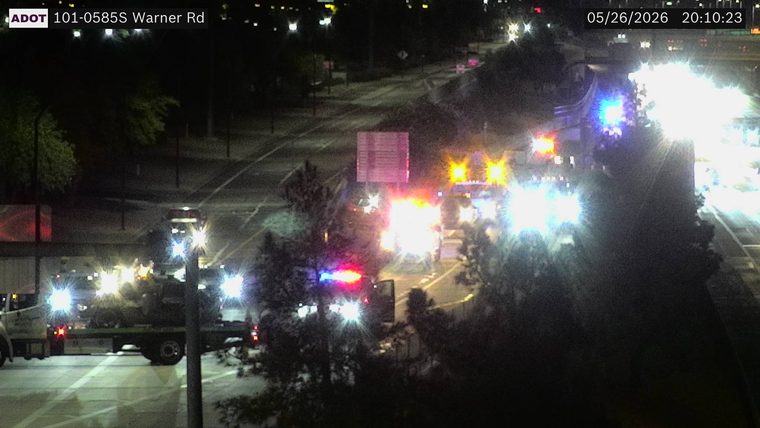Multiple emergency responder vehicles with flashing red, blue, and amber lights, including a tow truck, on the roadway.