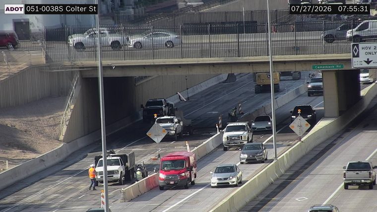 Construction workers and equipment in the right lane