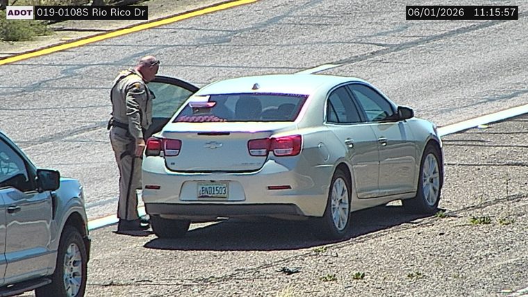 State trooper interacting with a driver on the right shoulder