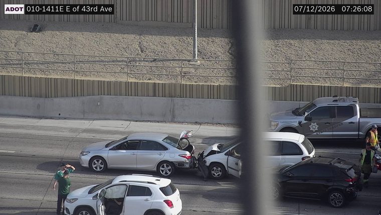 Two vehicles collided in the middle lanes, with visible damage to both.