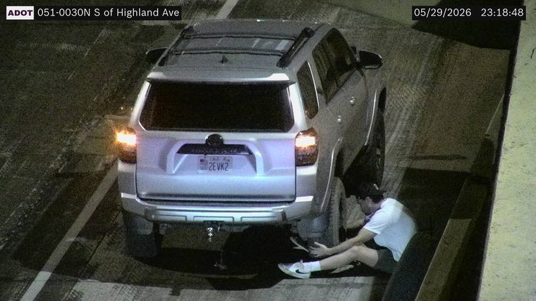 Person on the right shoulder near a vehicle