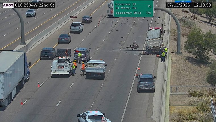 Dump truck overturned and debris in the right lanes