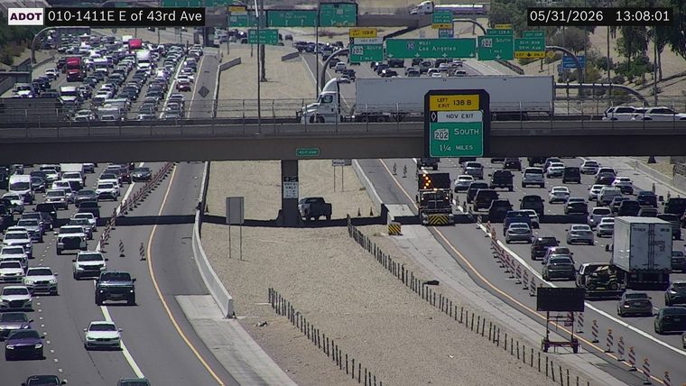 Truck with flashing lights and cones in the right lane