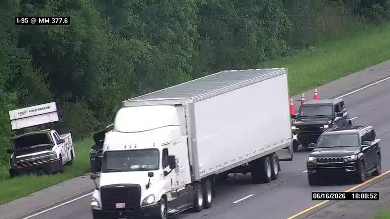 Road ranger truck with hood up, cones and traffic stopped on shoulder.