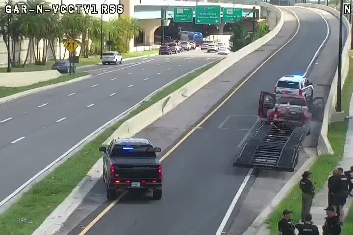 Police and tow truck on scene with a vehicle on a trailer.