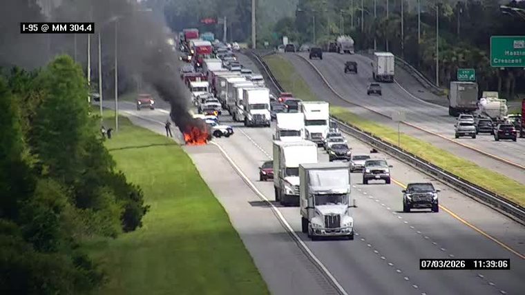 Vehicle fire with heavy smoke in the left lane