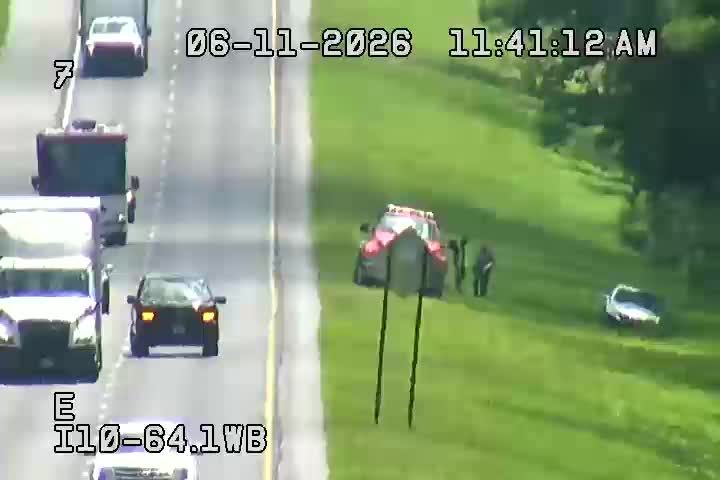 Emergency responders are on the scene with a vehicle on the shoulder.