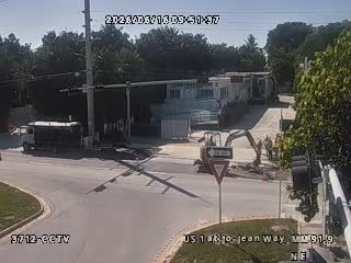 Construction crew and equipment working on the roadway.