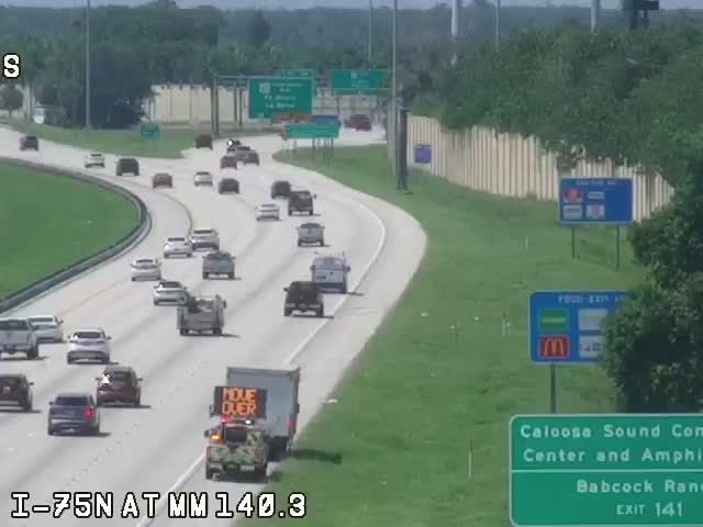 Traffic incident with a responder vehicle and "MOVE OVER" sign on the highway.