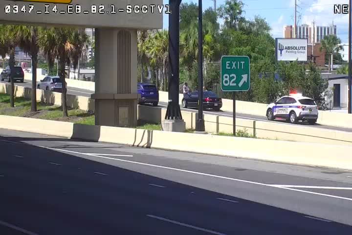 Police car with lights on at the side of the road near exit 82.