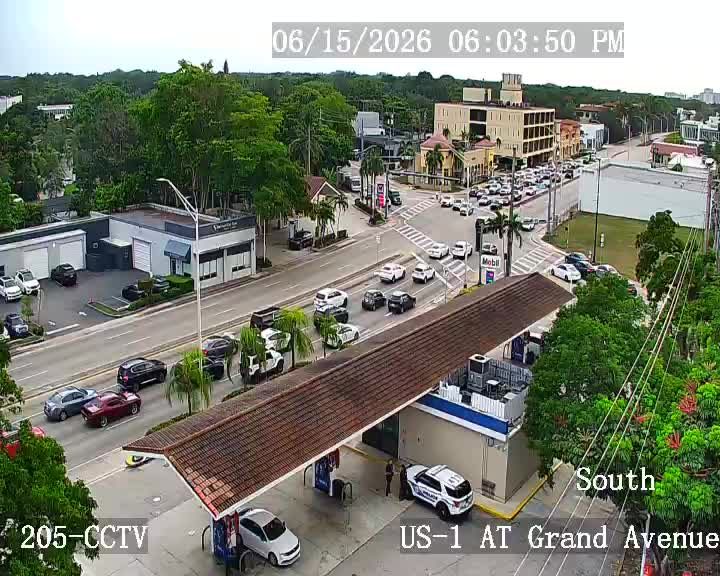 Police car and personnel at a gas station on US-1 at Grand Avenue.