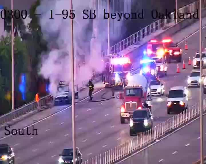 Vehicle fire on I-95 SB with responders and heavy smoke.
