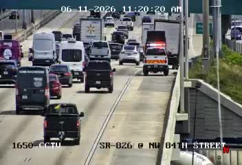 Emergency vehicle with lights on in traffic, likely responding to an incident.