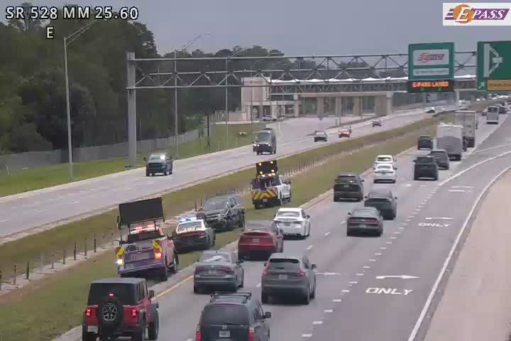Tow truck and police car on the right shoulder