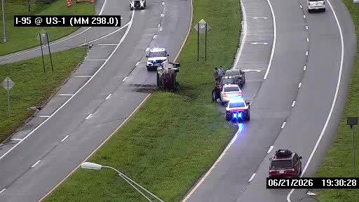 Police car with blue lights on the right shoulder