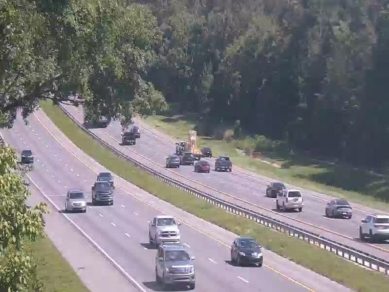 Emergency vehicle and equipment on the side of the highway.
