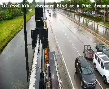 Emergency vehicle and personnel on scene with cones on the roadway.