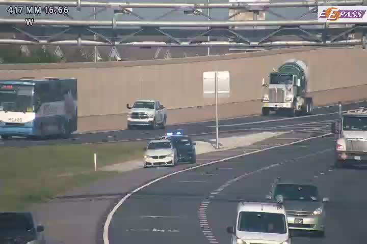 Police car with blue lights on the right shoulder