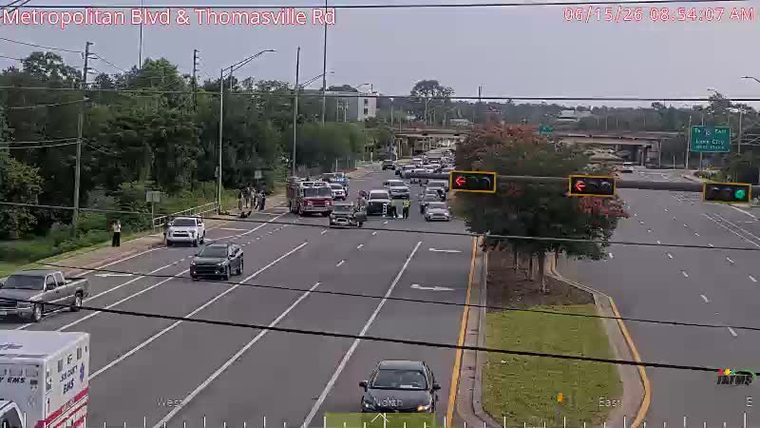 Fire truck and emergency personnel responding to an incident on the roadway.