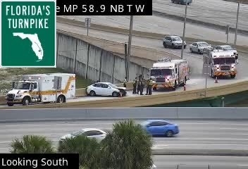 Emergency responders and vehicles are present on the roadside.