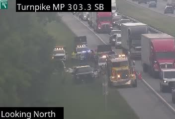 Multiple emergency vehicles with lights on in the median