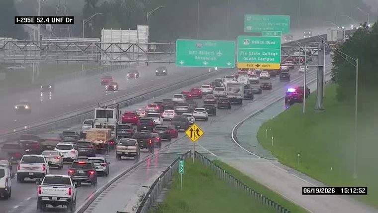 Police car with red and blue lights on the right shoulder