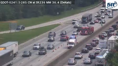 Fire truck and ambulance with lights on in the left lane