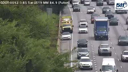 Tow truck and other vehicles stopped on the shoulder, possibly responding to an incident.