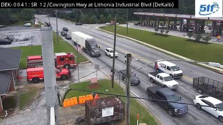 Fire trucks and other emergency vehicles are present on the roadside.