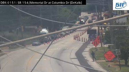 Traffic cones and a person on the roadside indicate a responder incident.