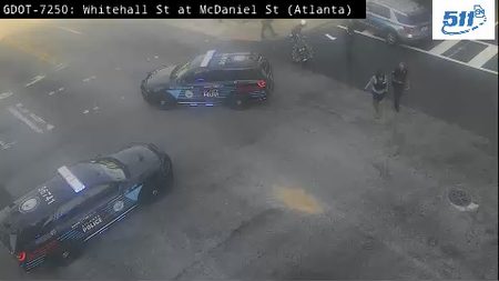 Two police officers are present at the scene with two police cars.