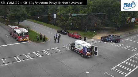 Fire truck, ambulance, and police car with multiple responders at intersection