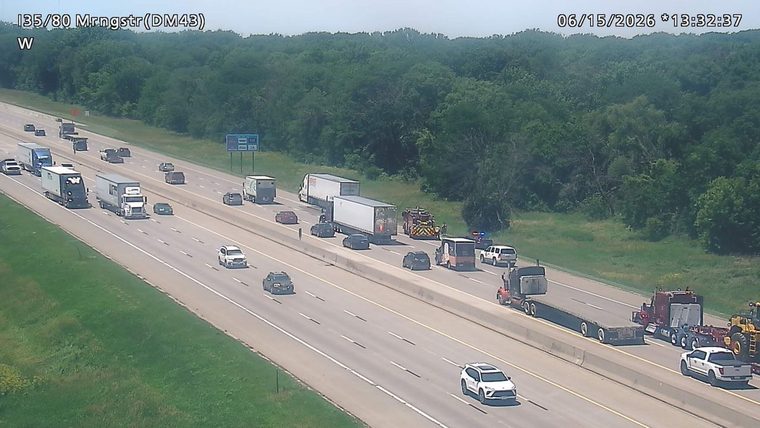 Emergency responders and vehicles are present on the highway shoulder.