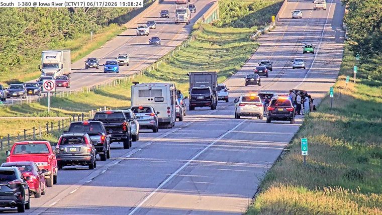 Emergency responders and vehicles are present at a roadside incident.