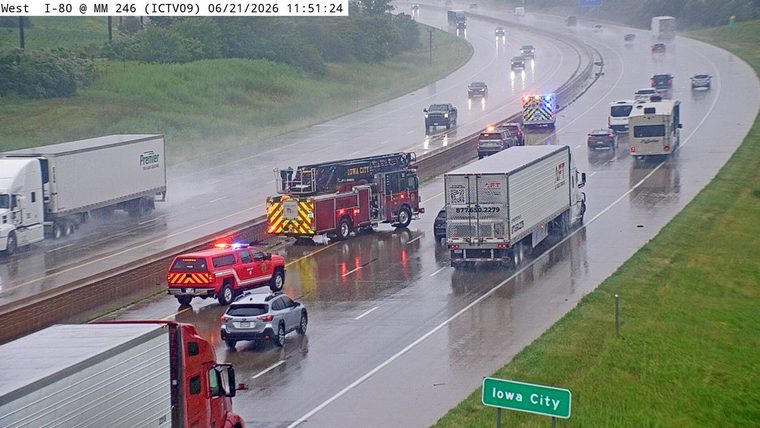 Fire truck and police SUV with lights on in the right lane