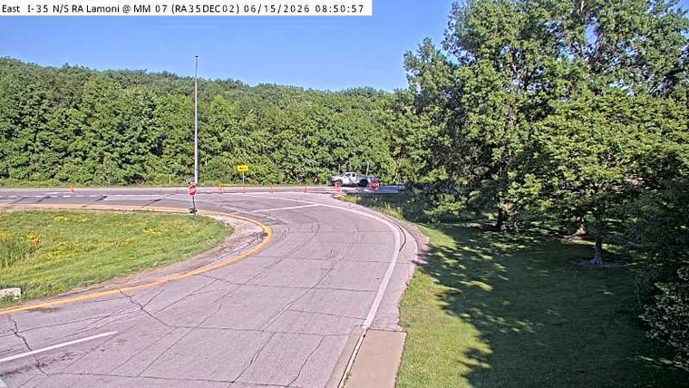White truck and cones on the side of the road, possibly a responder scene.