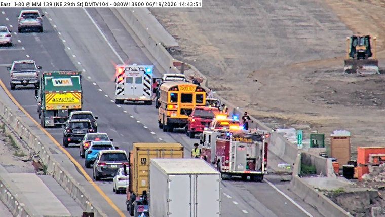 Multiple emergency vehicles and a school bus in the travel lanes
