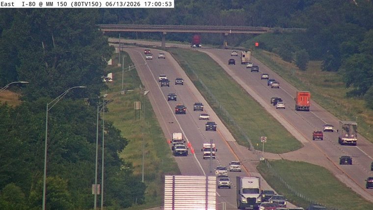 Emergency vehicles and cones on the roadway indicate an incident response.