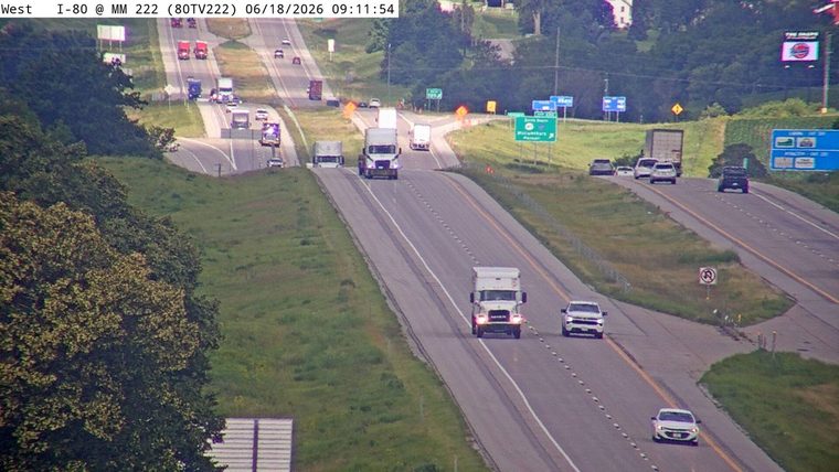Police car with flashing lights on the shoulder of the highway.