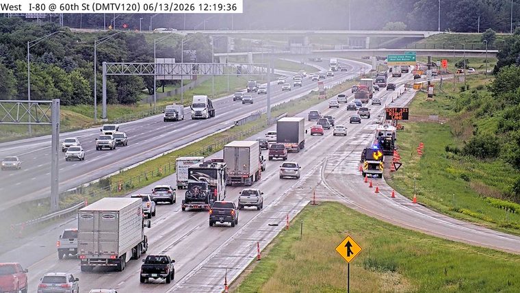 Emergency vehicles and cones on the right shoulder near Exit 121.