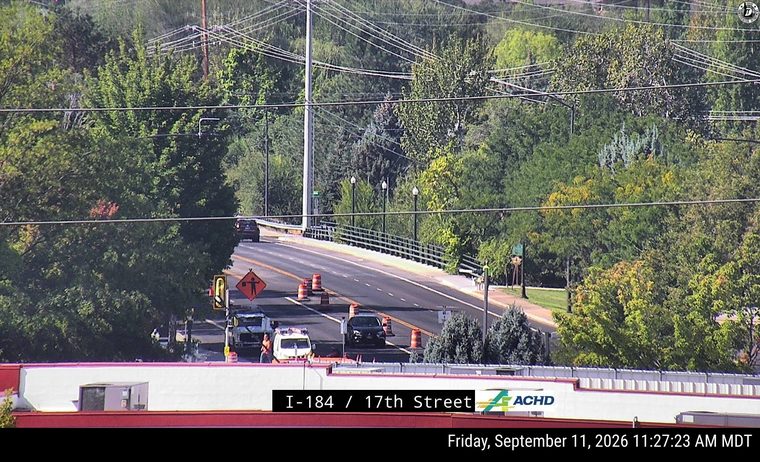 Construction cones and workers in the left lane