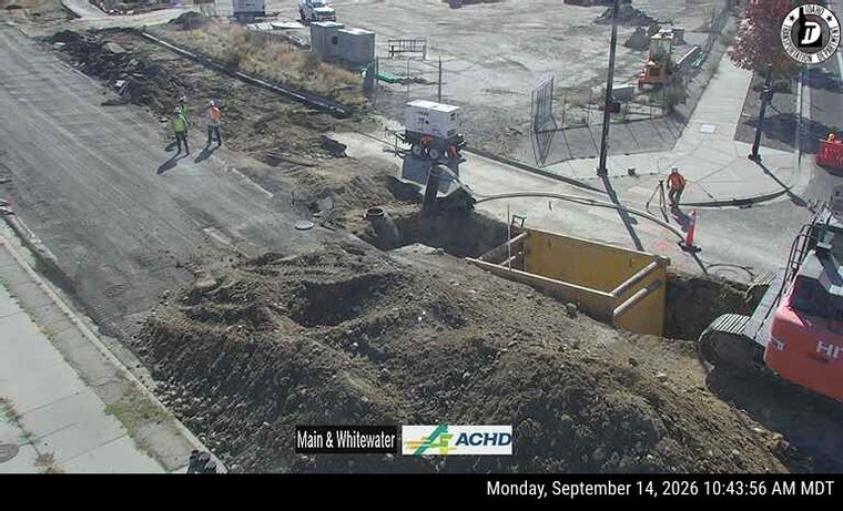 Construction workers and equipment in the roadway