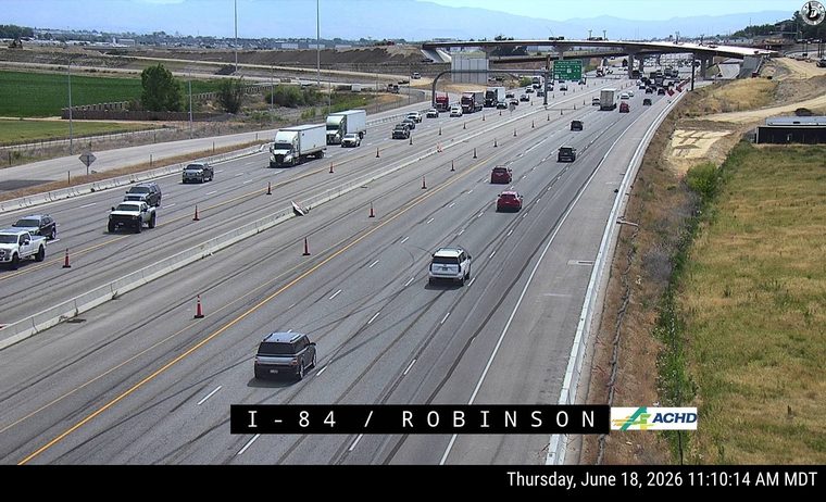 Debris on the roadway, traffic cones present, traffic moving normally.