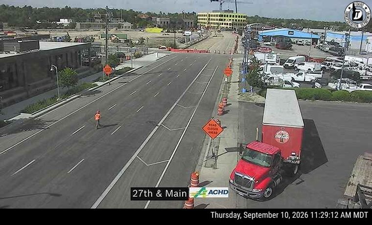 Person in orange vest on the roadway