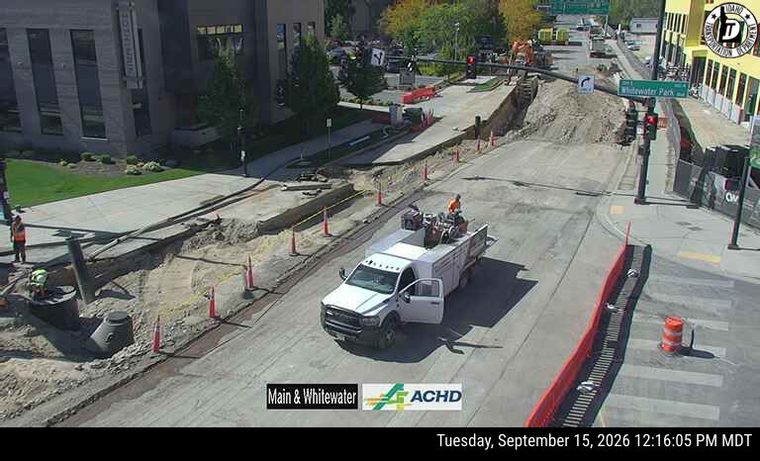 Construction workers and equipment in the roadway