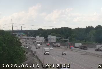 Emergency responders with flashing lights on the right shoulder of the highway.